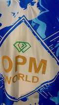 Close-up of OPM Clothing authenticity label on the hem of a blue custom soccer jersey.