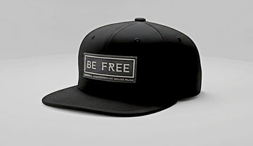 Black cap with 'BE FREE' text on a gray background
