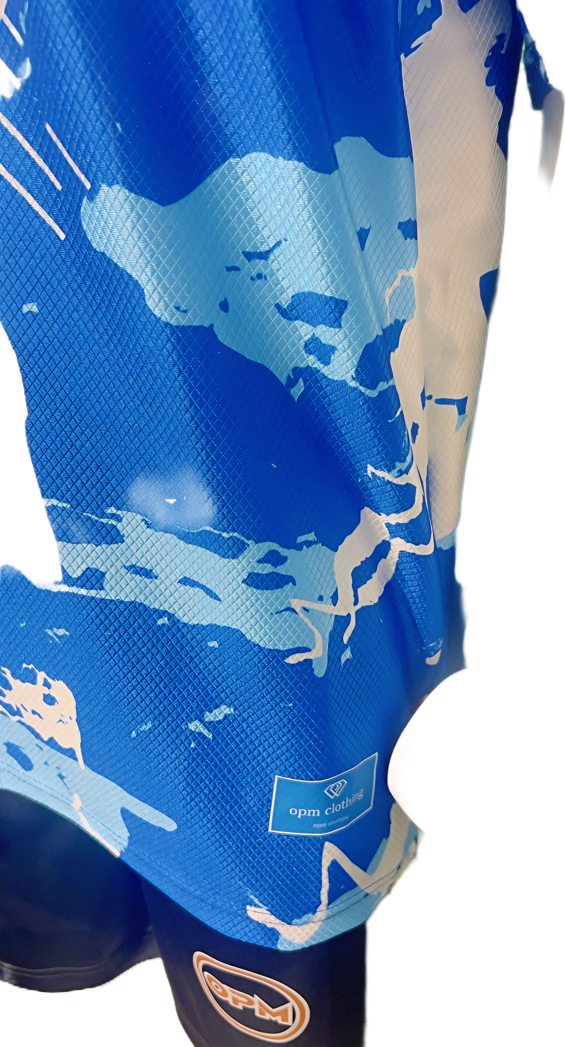 Macro shot of breathable performance fabric and OPM circular patch on a bespoke football top.