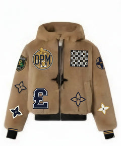 OPM Powerbook Jacket. Limited edition Culture Brown mink fur meets luxury streetwear. Beige hoodie with various patches on a white background