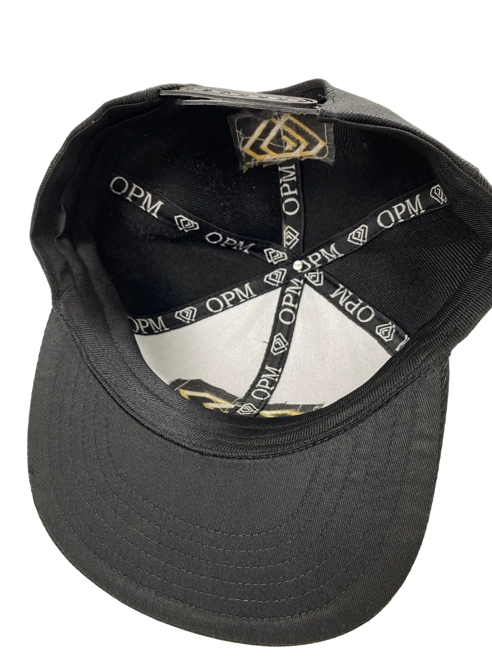 Black cap with 'OPM' branding on a white background