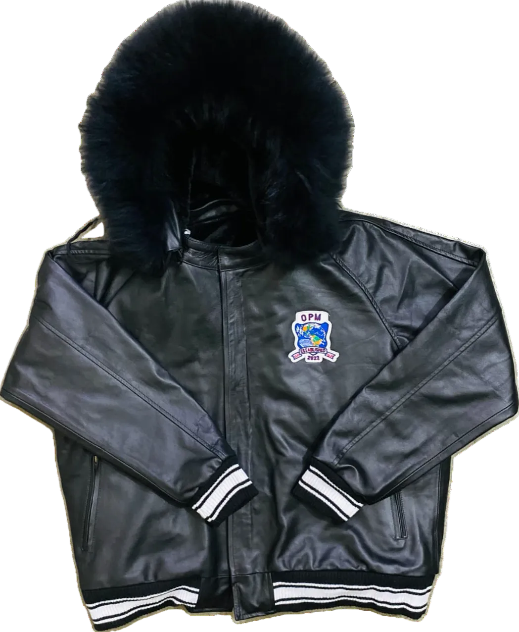 Black leather jacket with blue fox fur hood and embroidered opm logo on a white background