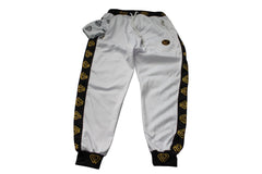 White sweatpants with black and gold accents on a white background