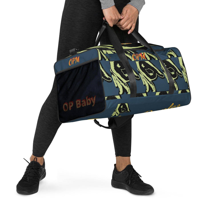 Person holding a blue streetwear duffle bag with green graphic design and OP Baby text