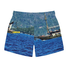 Men's swim trunks with vivid ocean and boat print, featuring bright blue water and scenic background