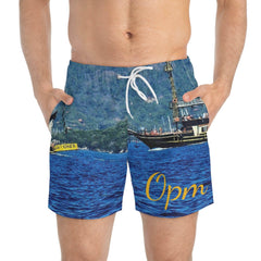 Men's swim trunks with ocean and pirate ship print, yellow 'Opm' text, drawstring waist