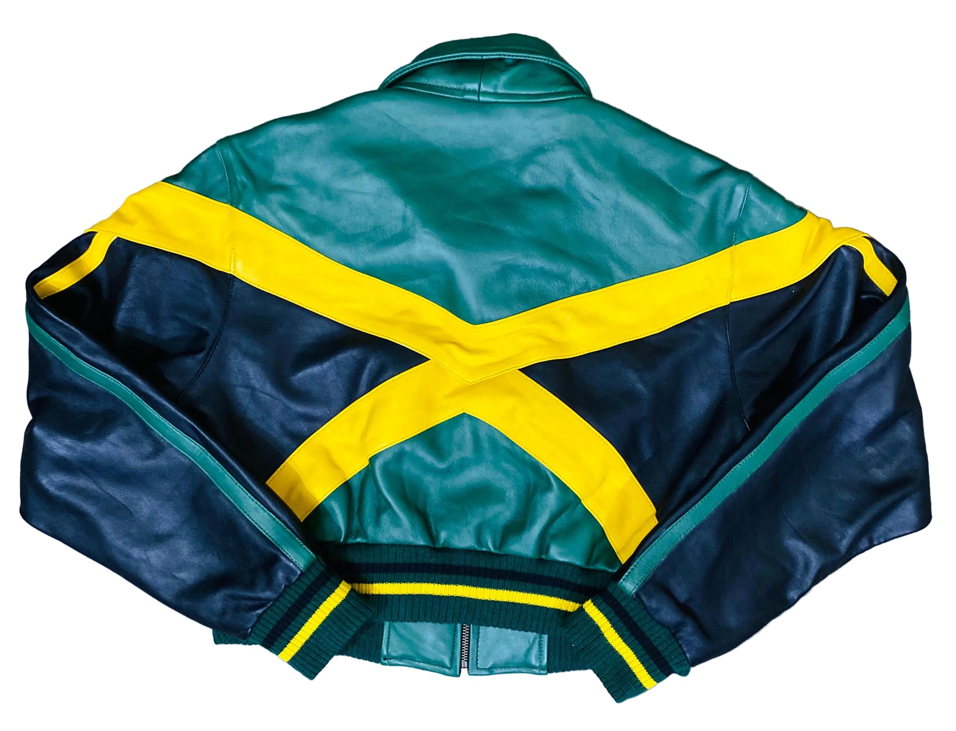 Green and navy leather jacket with yellow accents on a gray surface