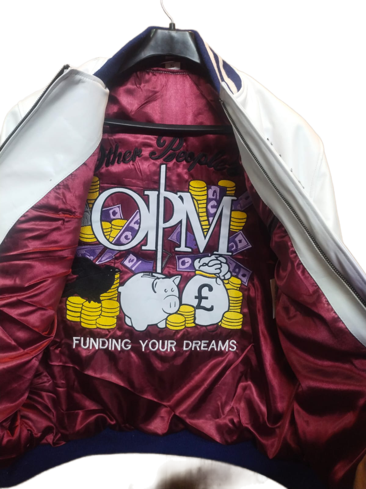 Maroon jacket inside lining with OPW logo and text on a white background