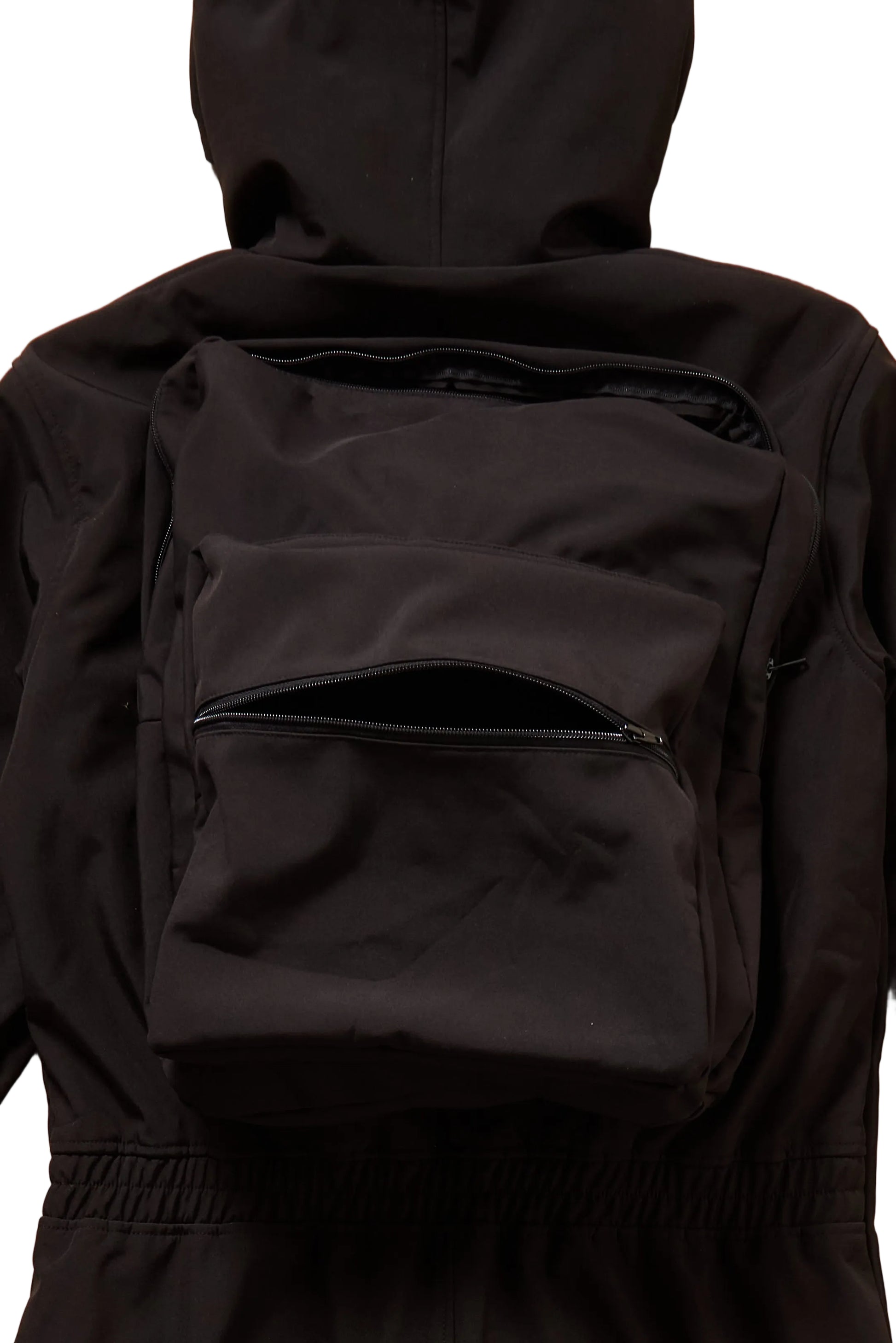 Black backpack worn by a person in a black jacket on a white background