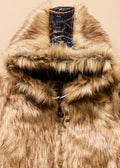 Close-up of a fur-lined hood with a brand label on a beige background