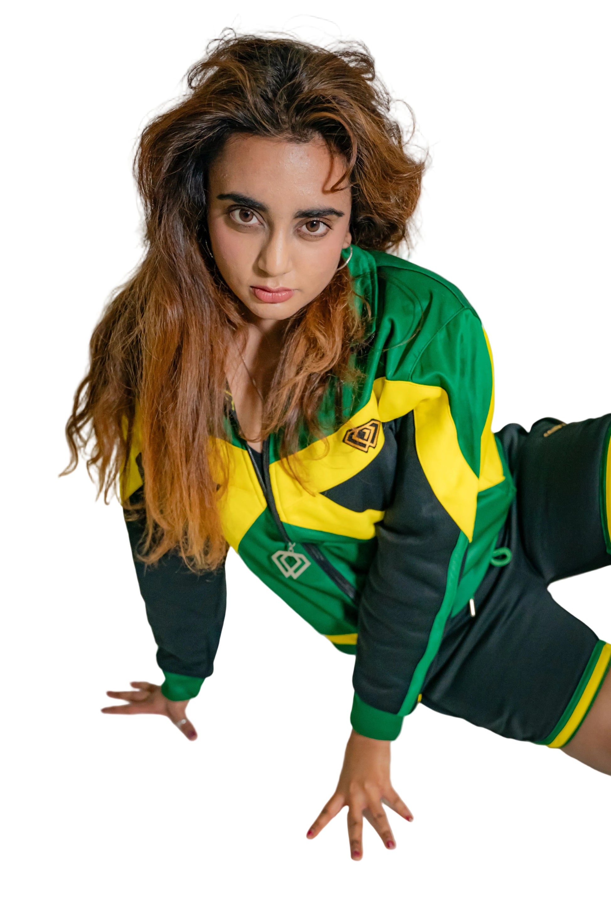 Person wearing a green and yellow tracksuit on a white background
