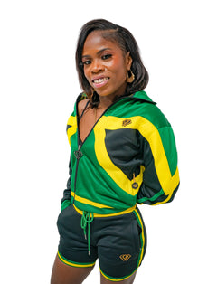 Person wearing a green, yellow, and black tracksuit with a logo on a gray background