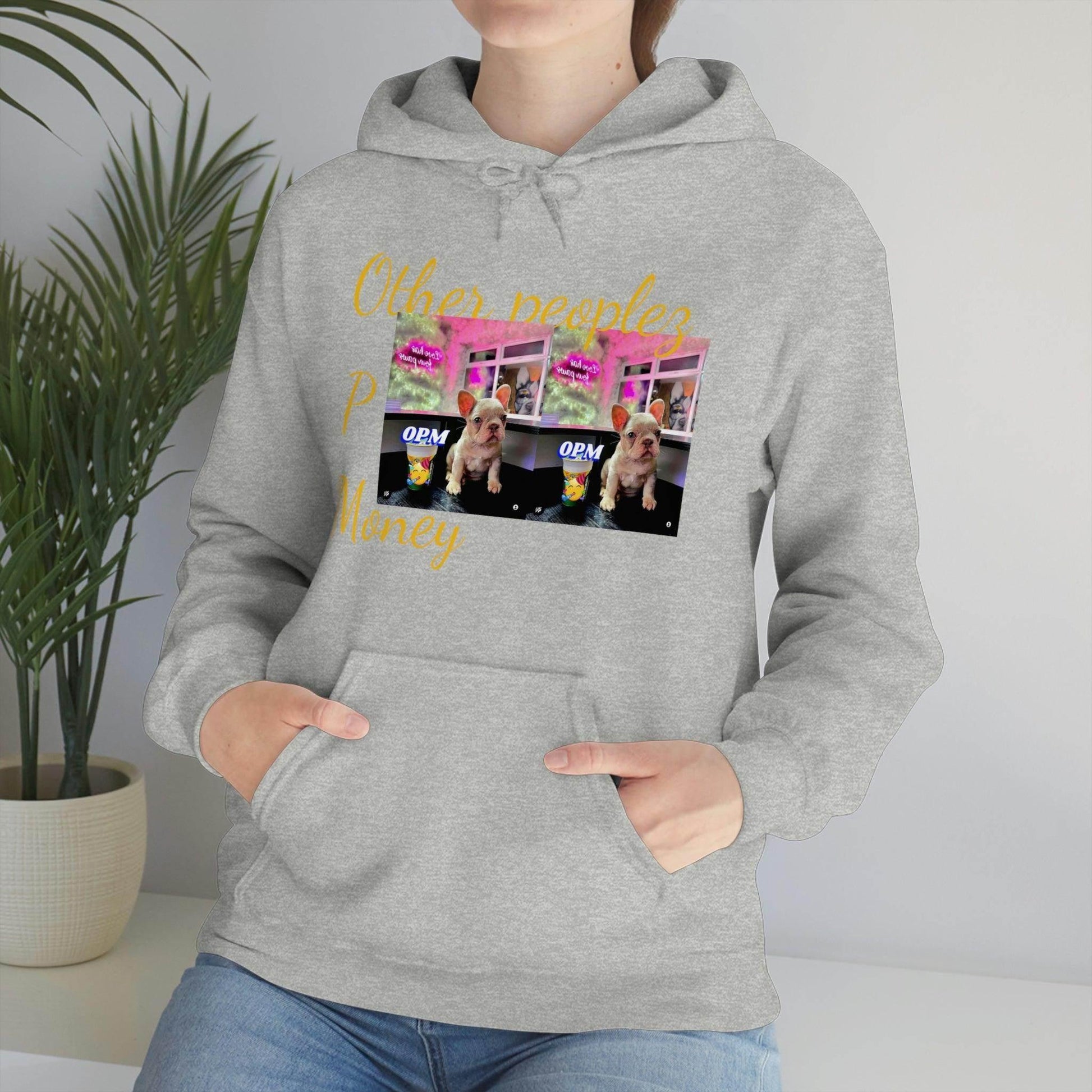Person wearing a gray unisex hoodie with French bulldog graphic and yellow text design
