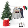 Grey graphic hoodie reading 'Other people’s money' on clothing rack with festive decor, holiday theme