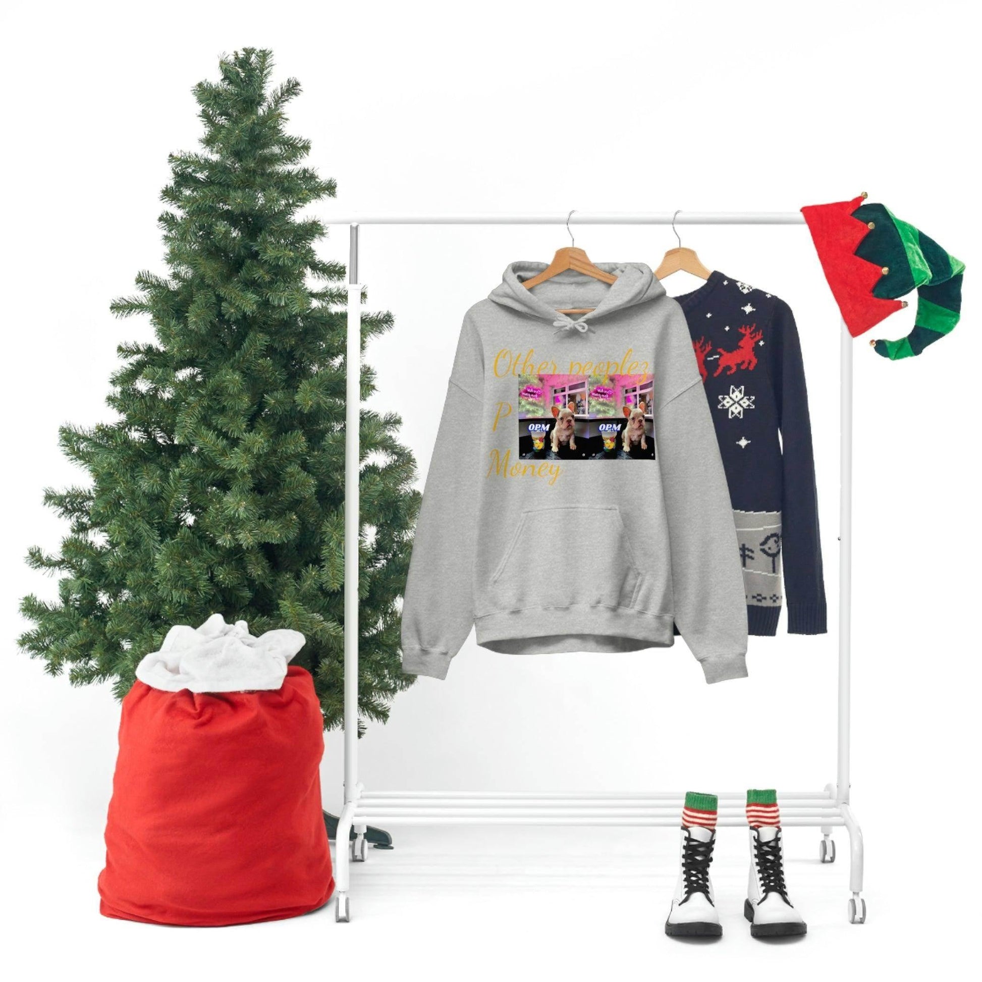 Grey graphic hoodie reading 'Other people’s money' on clothing rack with festive decor, holiday theme