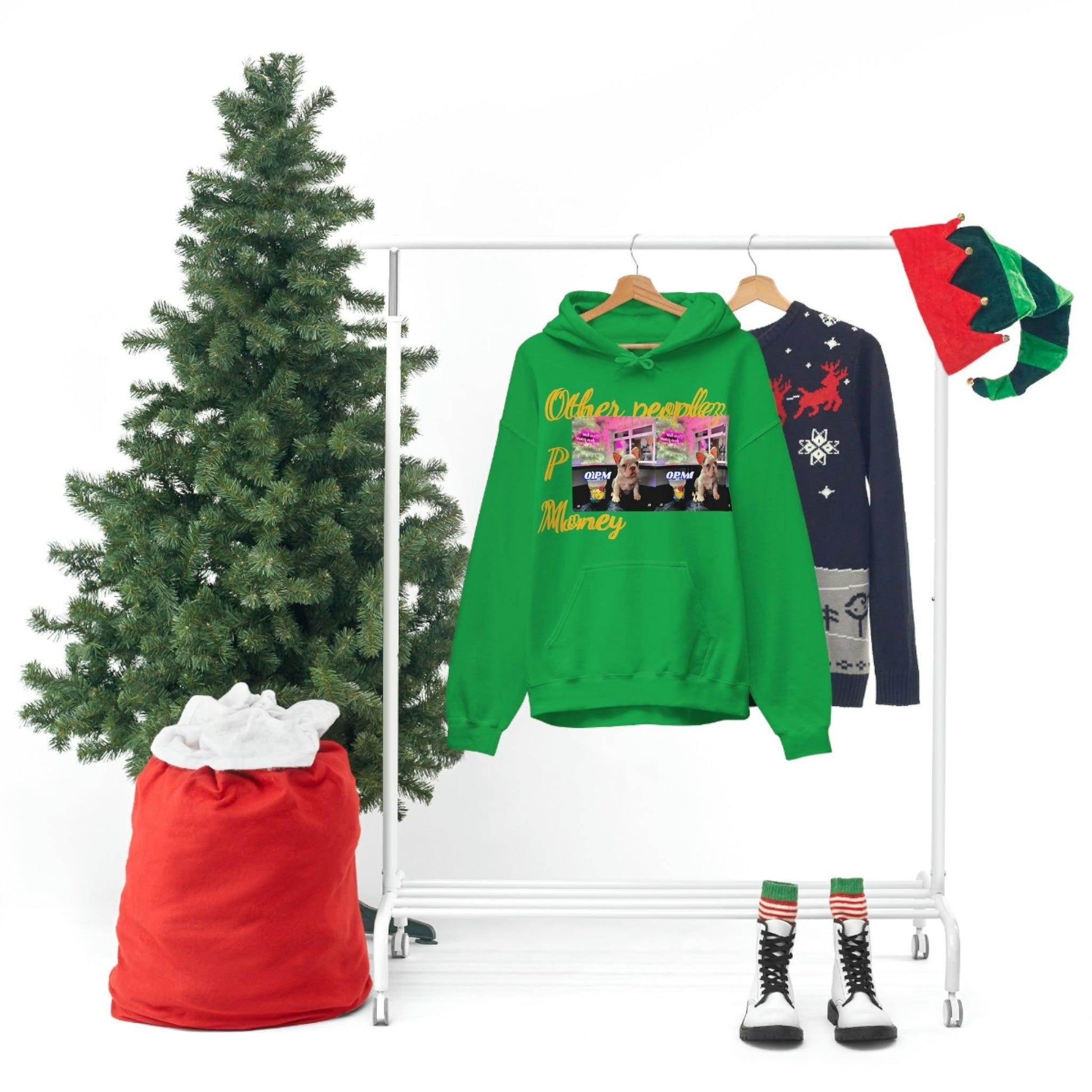 Green graphic hoodie with urban print on rack, festive Christmas decor, and winter sweater.