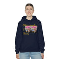 Woman wearing navy blue hoodie with yellow 'Other people’s money' text and graphic print, urban streetwear