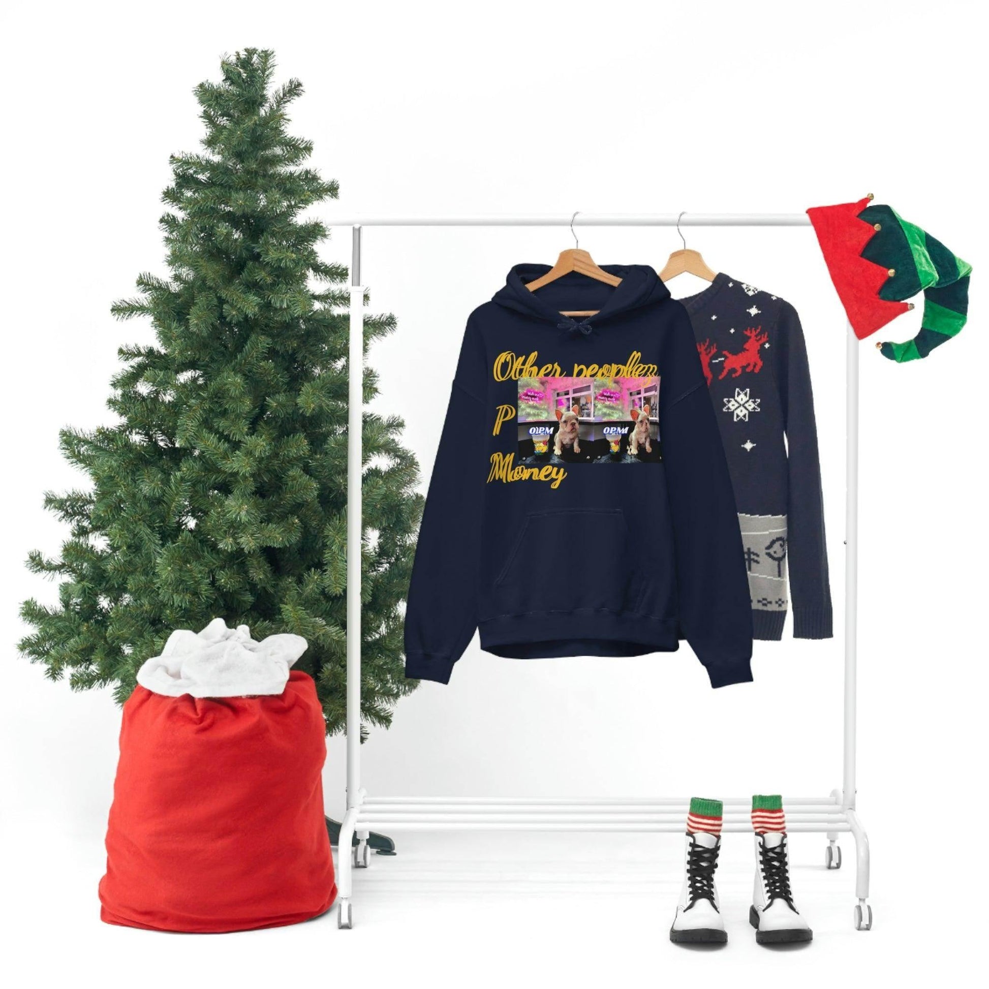 Navy graphic hoodie with 'Other Peoples Money' text on a rack, next to Christmas sweater, tree, red sack, elf hat, and festive boots.