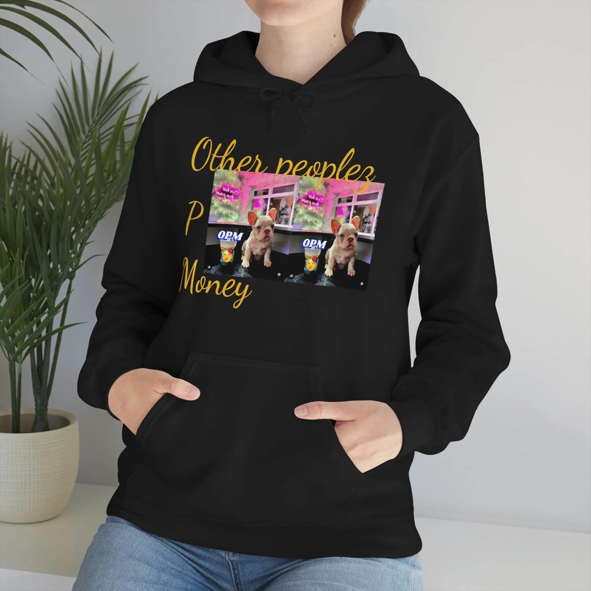 Woman wearing black hoodie with colorful dog print and 'Other peoples Money' text