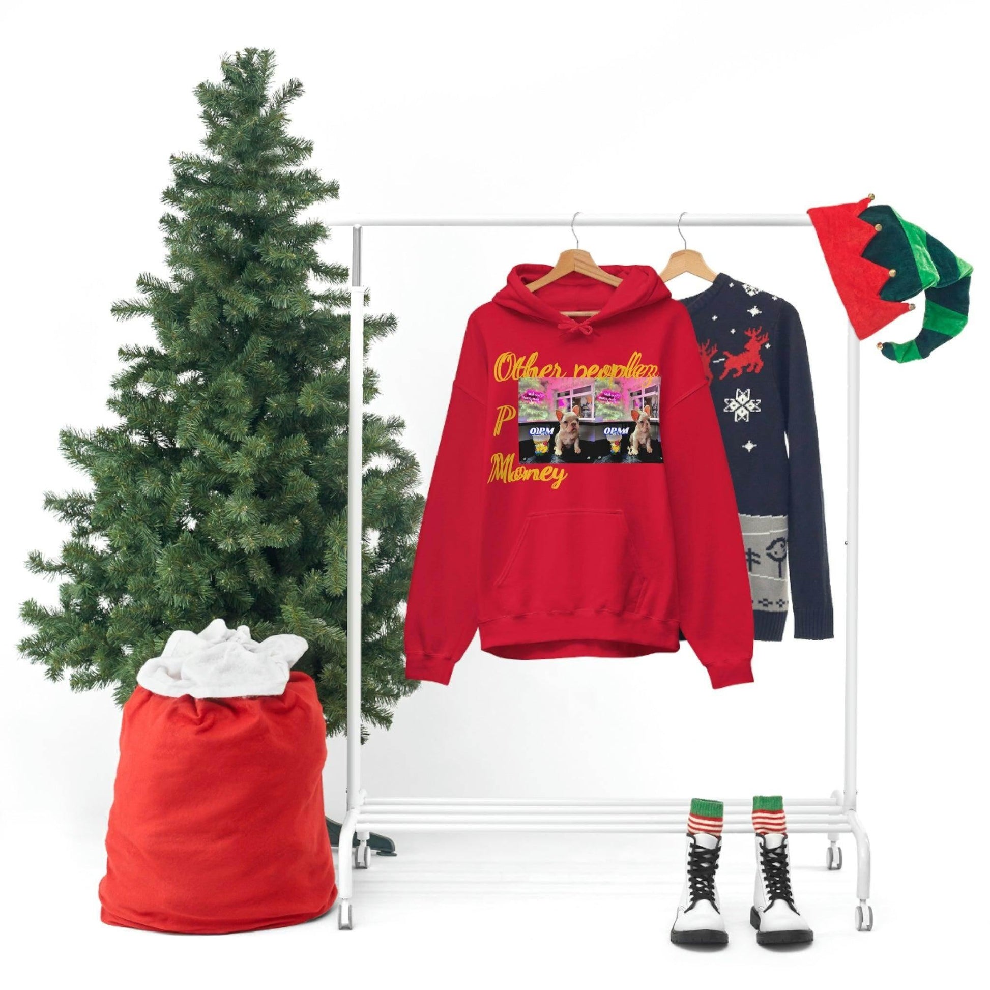 Red graphic unisex hoodie and Christmas sweater on rack with festive holiday decor