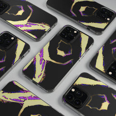 Black phone cases with bold gold and purple abstract designs arranged on a flat surface