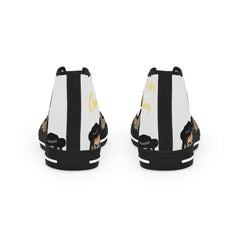 Back view of high-top sneakers with black and white stripes, cartoon face, and gold lettering design