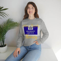 Woman wearing grey crewneck sweatshirt with 'HM PRISON SERVICE' graphic and gold text, casual style