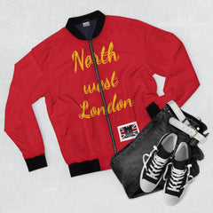 Red bomber jacket with 'North west London' text, black jeans, and black sneakers flat lay