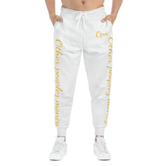 White joggers with gold script 'Other peoples money' on legs, worn by male model