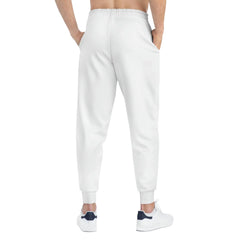 Back view of man wearing white joggers and white sneakers with navy accents