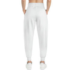 Back view of white joggers with elastic waistband and cuffed ankles, modeled with white sneakers