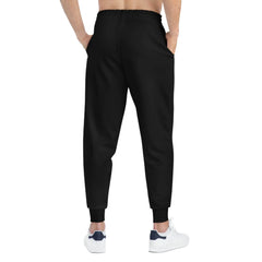 Back view of black jogger pants with elastic waistband and cuffed ankles, urban streetwear