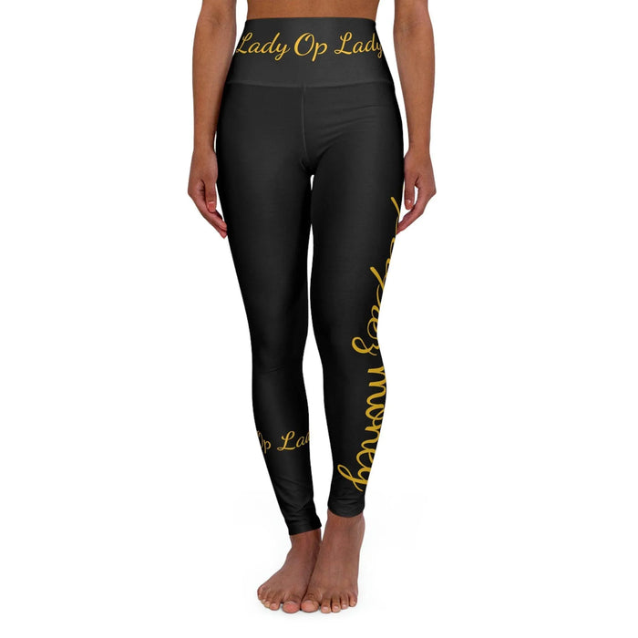 Black high-waisted leggings with gold script text, modeled on a white background