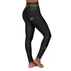 Woman wearing high waisted black leggings with gold script text, side view