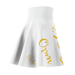 White women's skater skirt with bold yellow script lettering, modern streetwear style