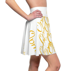 White skater skirt with bold yellow cursive script, urban streetwear style