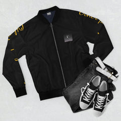 Black bomber jacket with yellow script on sleeves, paired with black jeans and sneakers