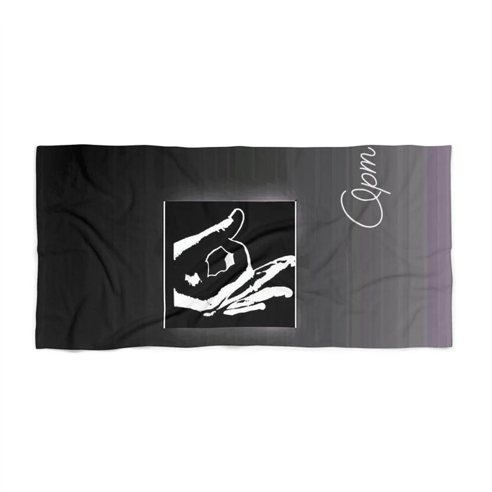 Black beach towel with bold white hand sign graphic and cursive 'Opm' lettering