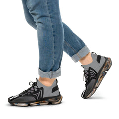 Person wearing grey and black mesh sneakers with transparent soles, paired with blue jeans