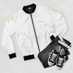 White bomber jacket with yellow script, paired with black jeans, white belt, and sneakers
