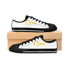 White and black low top sneakers with 'Opm' in gold script, displayed on a shoe box