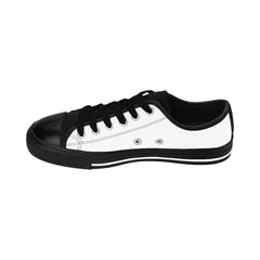 Low-top streetwear sneaker with black toe, laces, sole, and white canvas upper