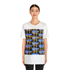 Unisex white streetwear t-shirt with colorful graphic and gold script design, urban fashion.