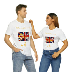 Two people wearing white t-shirts with UK flag graphic and gold text, posing together in jeans.