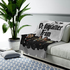 Velveteen plush blanket with cartoon dog mobsters draped over a modern sofa in a cozy living room