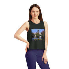 Woman wearing black cropped tank top with scenic print and 'Other peoples money, Op Lady' text