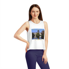 Woman wearing white cropped tank top with scenic print and text, urban streetwear style