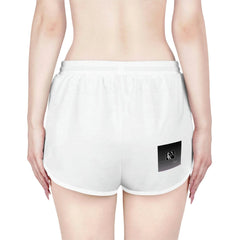 Back view of woman wearing white relaxed shorts with black patch detail, urban streetwear style