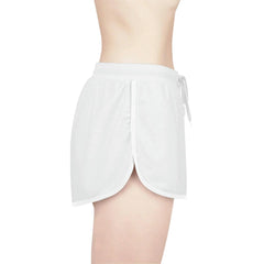 White women's relaxed shorts with elastic waistband and side tie on model, side view