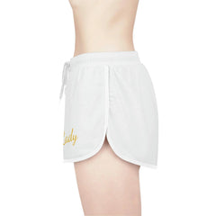 White women's relaxed shorts with gold script, elastic waistband and drawstring, side view
